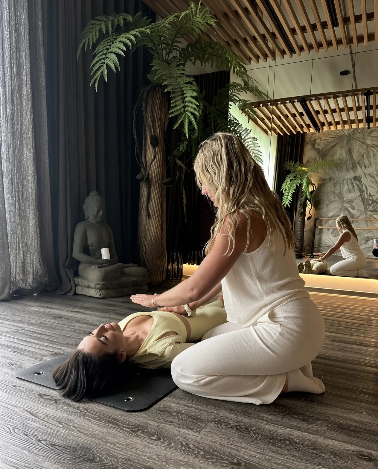 Katerina Kaslova guiding a client through a 1:1 breathwork session, one hand resting above her belly